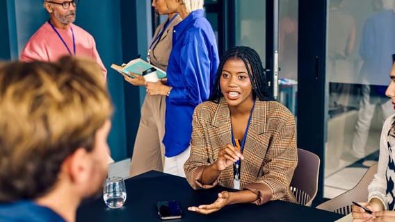 Woman talking to coworkers during a work meeting