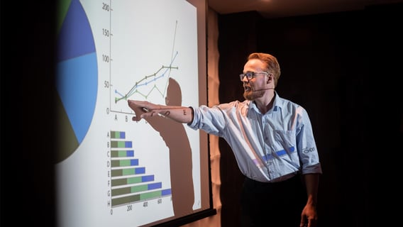 A professional reviewing data dashboards in an office, representing careers after an MBA Data Analytics.