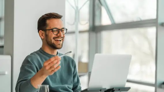 Man smiling during a virtual session, reflecting interactive and accessible MBA Online learning.