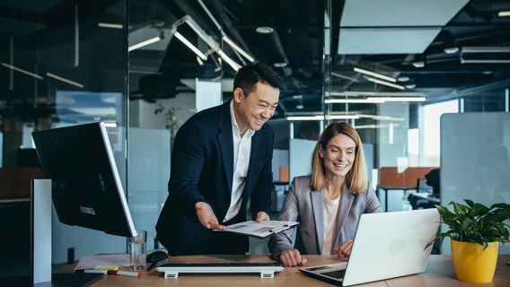 A professional analysing data on multiple screens, linked to risk management roles after an MBA Cyber Security.