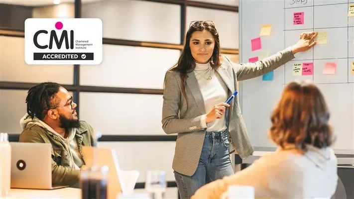 Businesswoman in blazer leads project planning meeting.