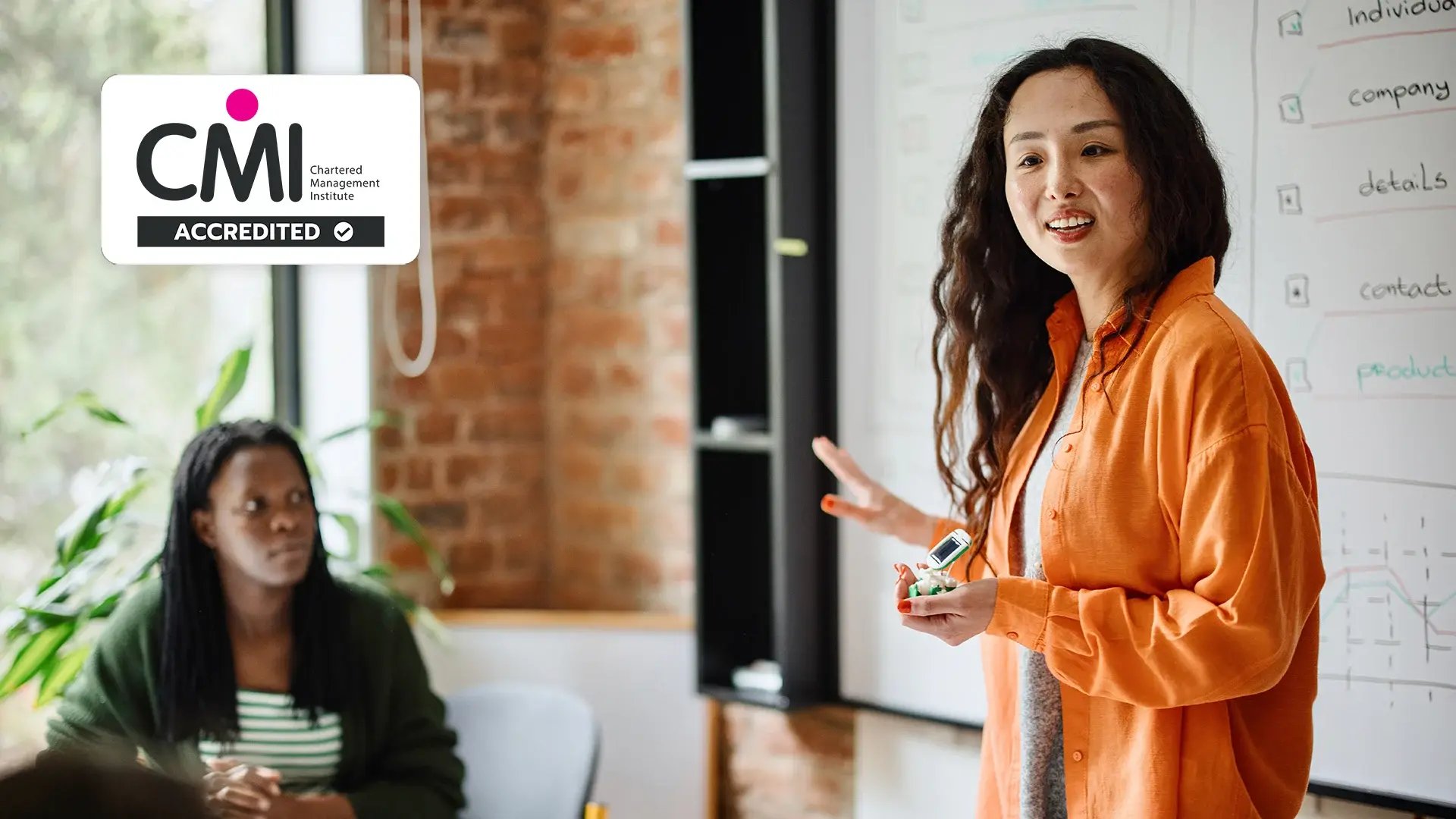 Woman in orange shirt in a management meeting.