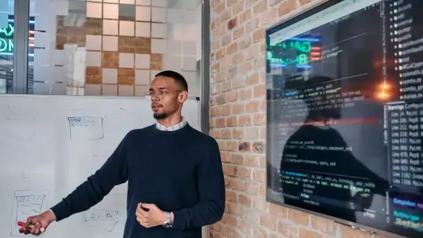 Systems engineer presents programming of operating systems in a modern office building.