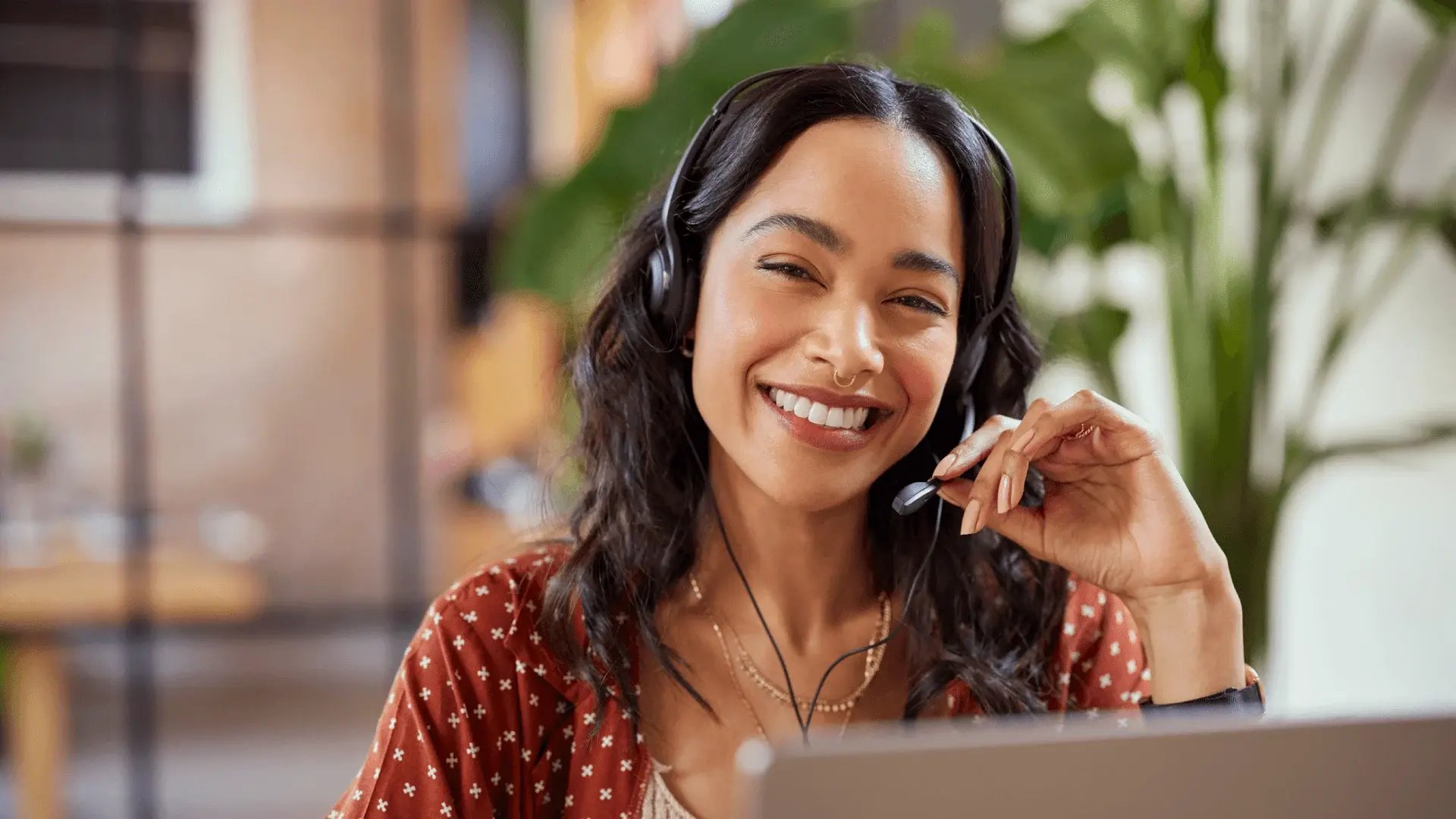 Friendly woman with headset offering support with postgraduate study.
