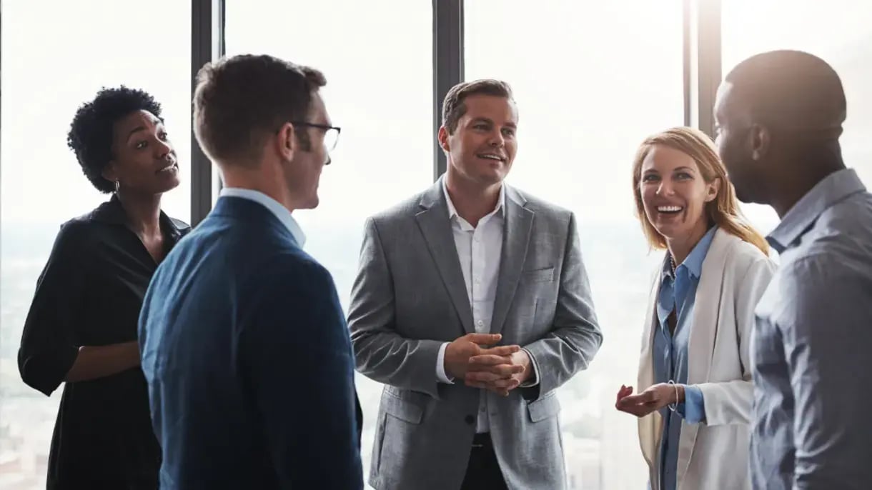 Group of people in conversation smiling 