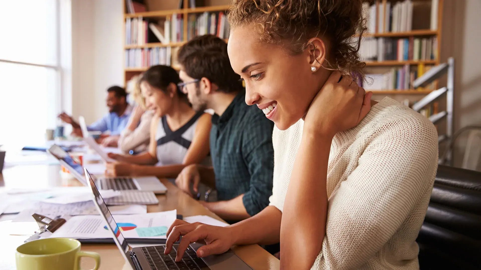 A group of people on their laptops.