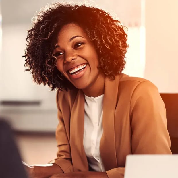 Woman smiling wearing a blazer.