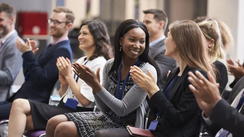 Young woman at an event applauding