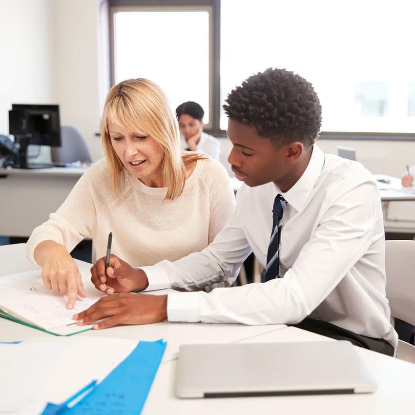 A teacher helping a student.