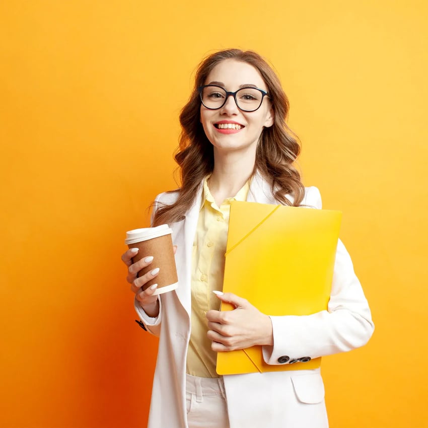 A woman holding a paper cup and a yellow folder.