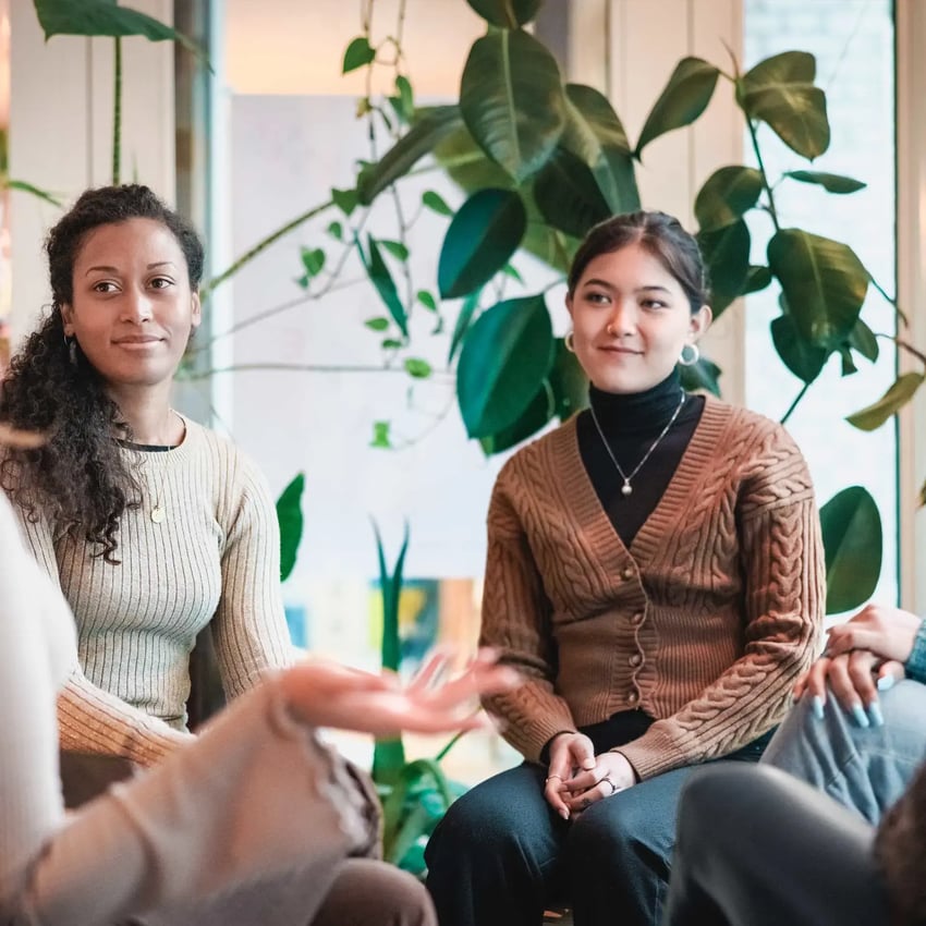 Two women in modern office take part in group workshop led by MSc Psychology graduate