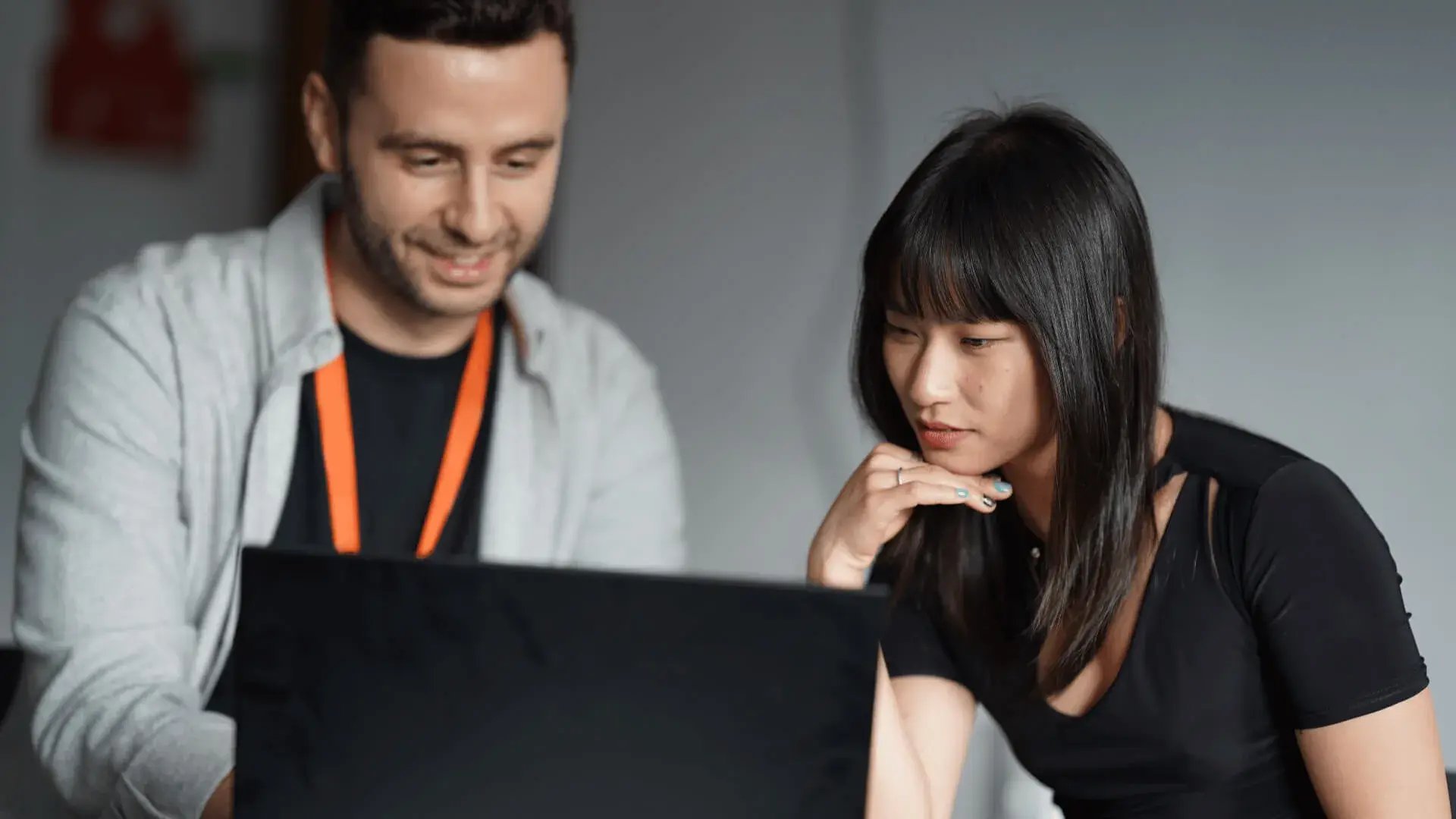 Man and woman consider the ethics of a product being developed by AI engineers.