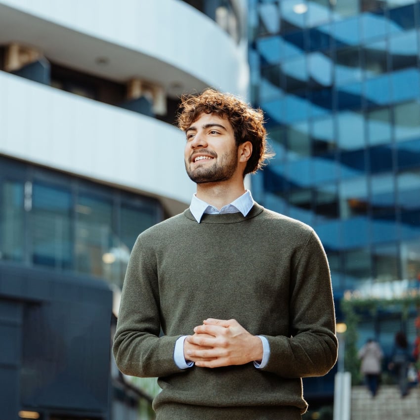 Man smiling and walking through corporate inner city environment